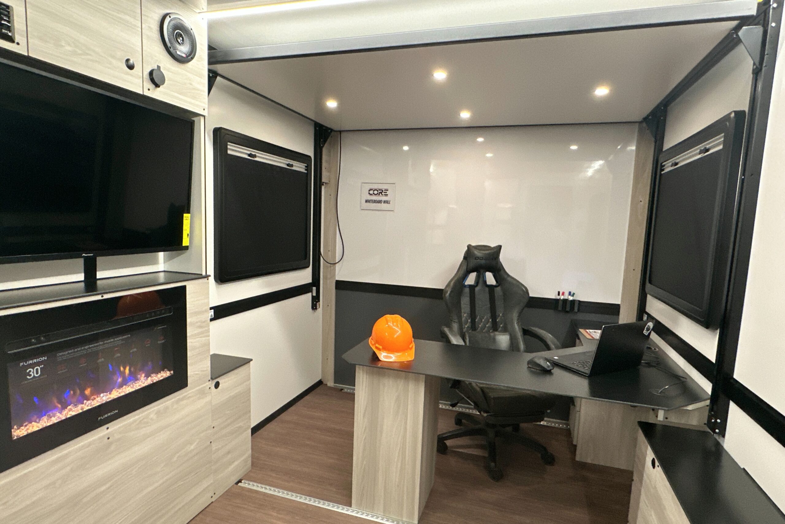 3D renderings of a CORE trailer 8019 model that is set up for a office space